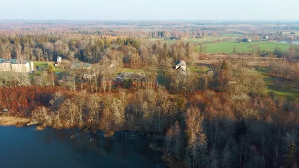 Old Red Brick House, Katvari Manor in Latvia and Katvaru Lake in the Background. Aerial Dron Shot 4K alt