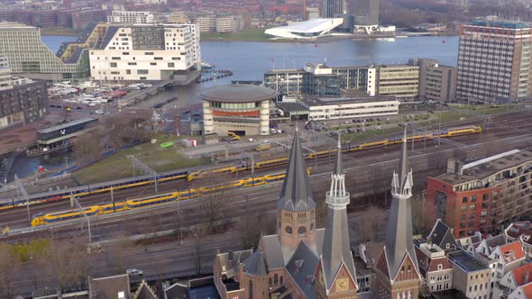 Trains Arriving and Departing Amsterdam Centraal Station in the Evening Aerial alt