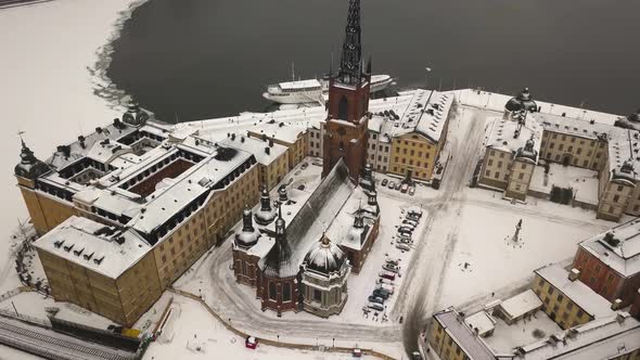 Zoom out cinematic aerial view of historic Riddarholmen church located in Old Town (Gamla Stan) of S alt