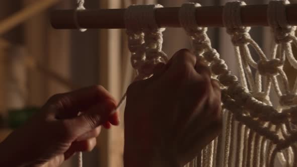 Woman Weaves Pattern of Macrame Threads with Her Own Hands for Decoration or Home Decor alt