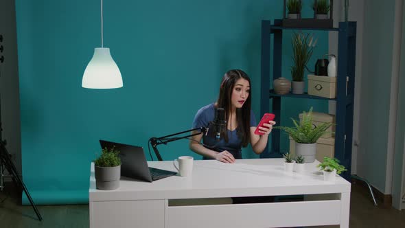 Content Creator Filming Online Podcast and Reading Good News alt