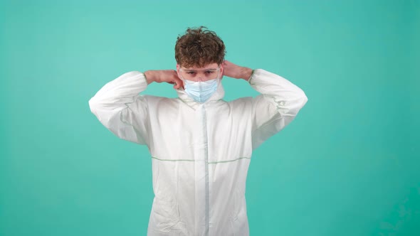 Man That is Wearing Protective Suit Medical Mask and Goggles Looking at Camera alt