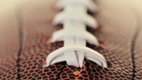 Close up of brown leather and white laces of American Football. alt