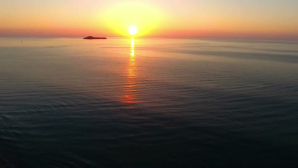 Colorful Sunrise over Caribbean Sea with Pelicans Crossing Aerial Drone View