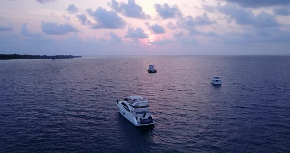 Beautiful above abstract shot of a summer white paradise sand beach and blue sea background in 4K alt