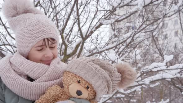 Child with Teddy Bear in Winter alt