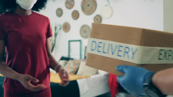 African-american Woman Receives Package While Staying Home. alt