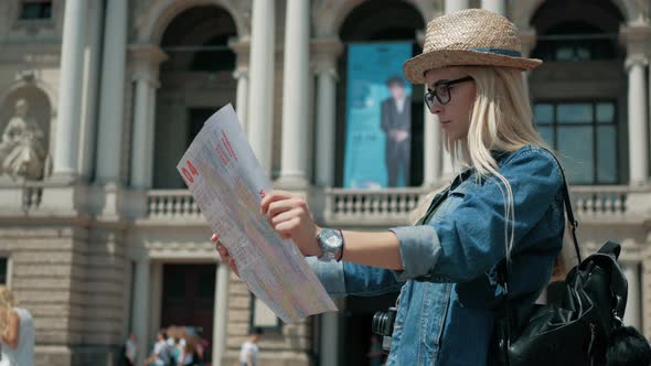 Young tourist woman exploring city map of lviv while traveling in Ukraine, vacation concept