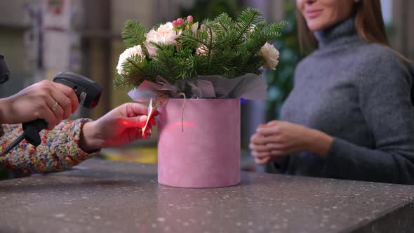 Unrecognizable Seller Scanning Barcode on Bouquet and Buyer Walking Away in Slow Motion alt