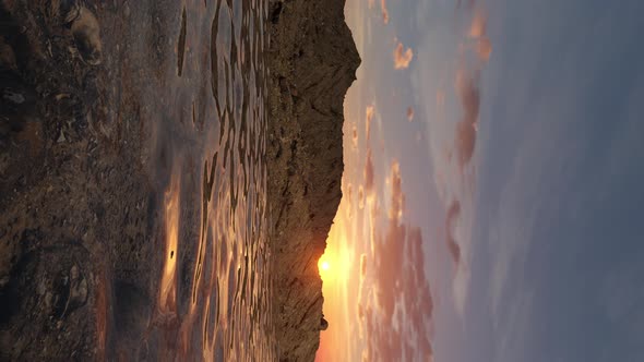 Vertical Rocky Desert 3D Rendered Terrain Landscape with Looping Clear Water at Sunset
