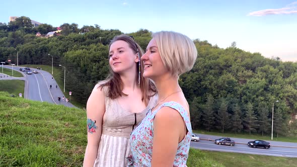Two Beautiful Girls Posing and Smiling in the Park