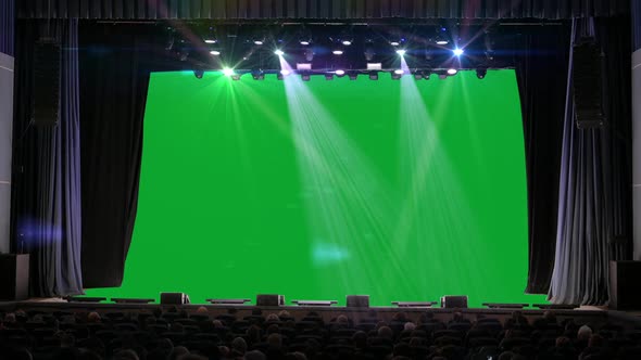 People Sit in the Auditorium and Look at the Green Screen