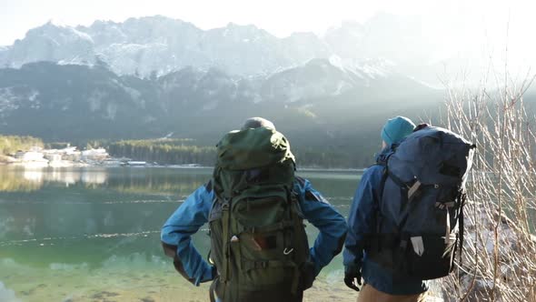 Real time shot of two hikers enjoying lake view, Bavaria, Germany