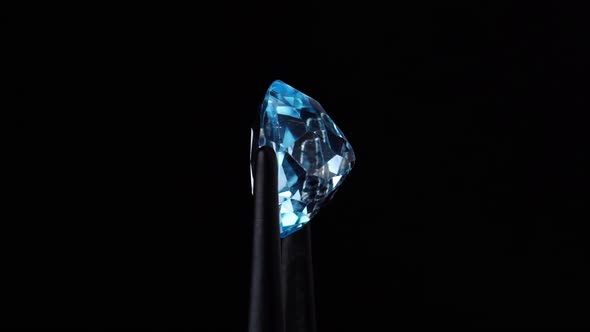 Natural Blue Topaz Oval Cut in the Turning Tweezers