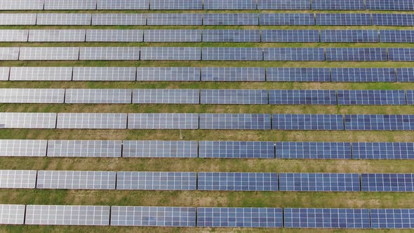 Flight Over the Solar Power Station Rows Panel Glide Moving Among the Cells alt