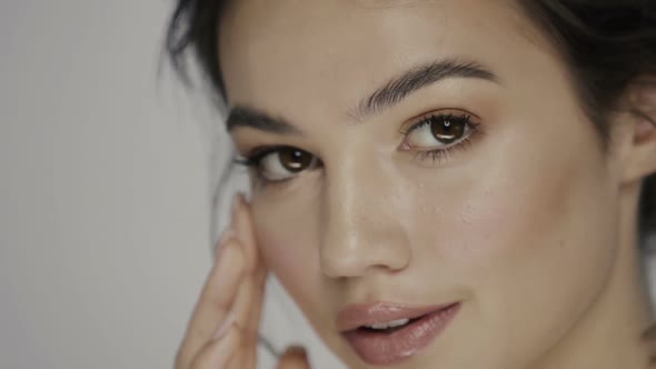 Beautiful Model Massaging Her Under Eye Zone and Cheek alt