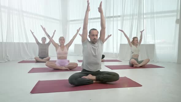 Young Sporty Attractive People Practicing Yoga Lesson with Instructor alt