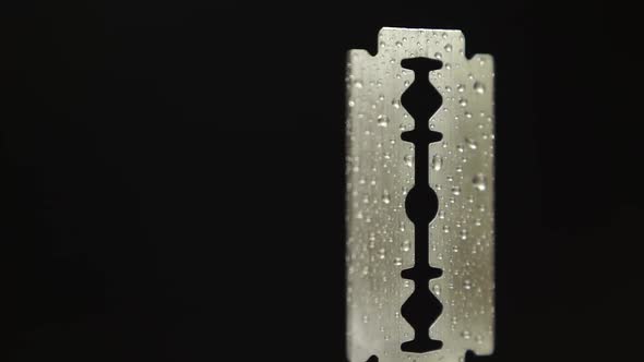 Traditional Razor Blade With Water Droplets On Black Background