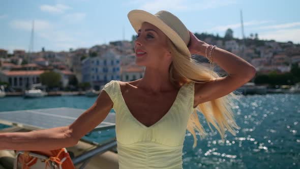 Beautiful Woman on a Yacht Enjoys the Journey Poros Greece Europe alt