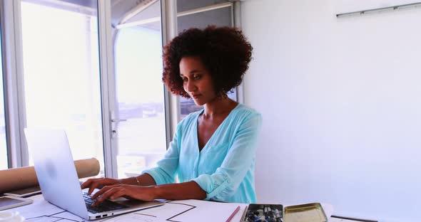 Female architect working on blueprint over drafting table 4k alt