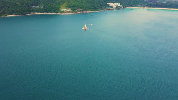 Drone footage aerial top view of catamaran sailing in the open sea . Thailand Nui Beach alt