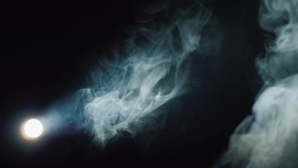Lantern Illuminates Smoke on a Black Background alt