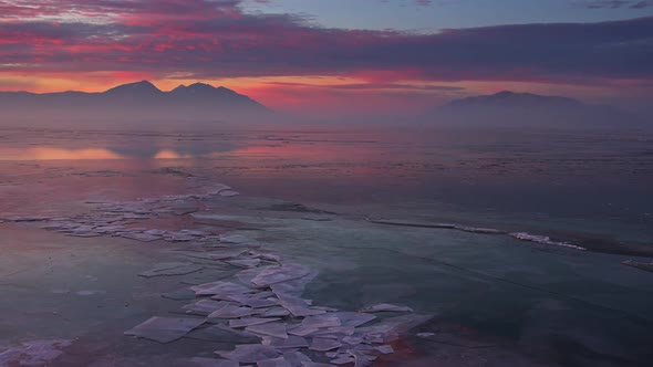 Panning over cracks in the ice durning sunrise over Utah Lake alt