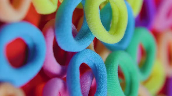 Multi Colors Rubber Bands Red Background  Vertical Screen alt