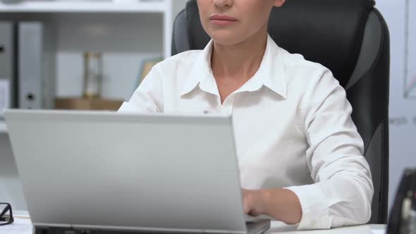 Serious Businesswoman Working on Laptop in Office, Important Project, Close-Up