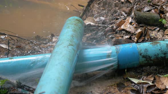 Broken or leaking Industrial pipe with water, water leakage from damaged rusty pipe, slow motion alt
