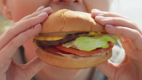 Happy Smiling Woman Eating Delicious Juicy Delicious Cheeseburger RED Footage alt