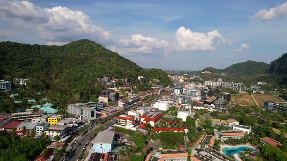 aerial drone of traffic and cars in Ao Nang Krabi Thailand surrounded by large mountains on a sunny alt