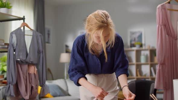 Beautiful Woman Fashion Designer is Working in Her Studio Apartment on a New Dress alt