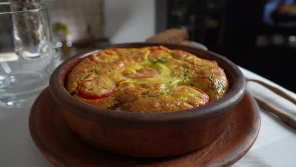 Vegetable frittata with egg, tomato, pepper, onion, cheese and green wild garlic alt