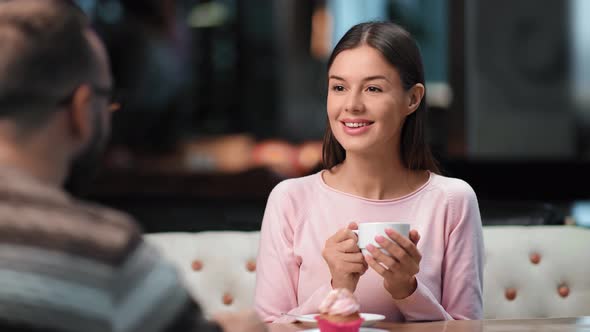 Happy Female Smiling Drinking Tea at Cafe Talking with Male on Date alt