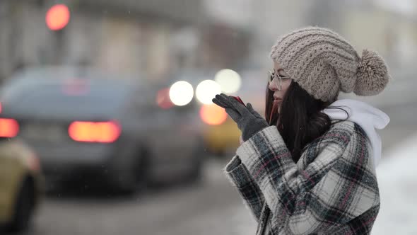 Woman is Talking By Loudspeaker in Smartphone or Communicating By Voice Message alt
