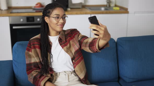 Young Beautiful Smiling Girl with Dreadlocks Taking Selfie Picture with Smart Phone Camera alt