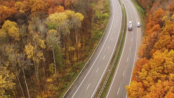 Cars and Trucks Drive on Lanes of the Autobahn - Cargo Concept
