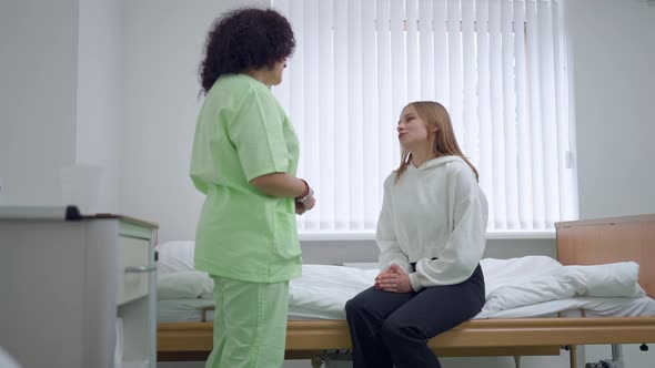 Happy Woman Thanking Doctor for Care Shaking Hands with Physician Sitting on Bed in Ward alt