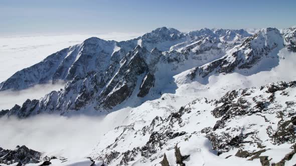 Panoramic view of foggy valley between High Tatras mountain snow capped jagged peaks, Slovakia alt