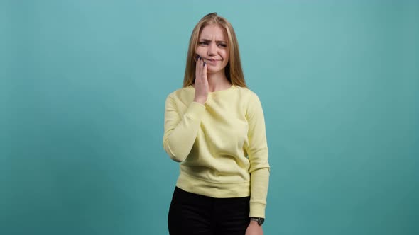 Young Woman Isolated on Turquoise Background Suffering From Severe Toothache alt