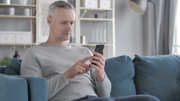 Gray Hair Man Browsing on Smartphone Using Internet alt