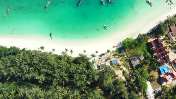 luxury resorts on the tropical island. Palm trees, calm emerald water and sandy beach. Thailand, alt