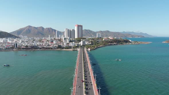 Shooting Aerial Unmanned Flight From Top View of the City Bridge with Cars and Motorbikes Against alt