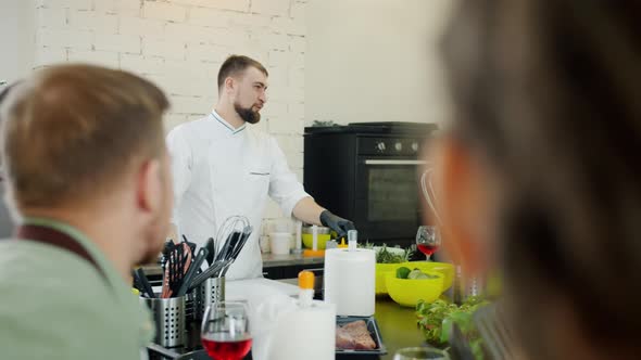 Cheerful People Chef and Cooking Class Students Talking Indoors Enjoying Cookery alt
