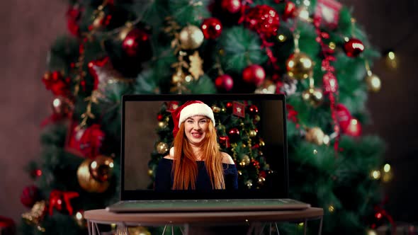 Woman Congratulates Relatives Christmas Through Laptop Using Videoconference App alt