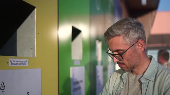 Waste Separation Office of Man Throws Plastic Garbage for Recycling and Stands on Street Spbd alt