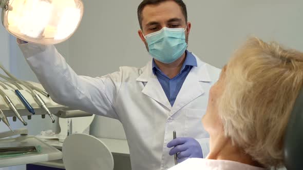 Dentist Turns on the Dental Light