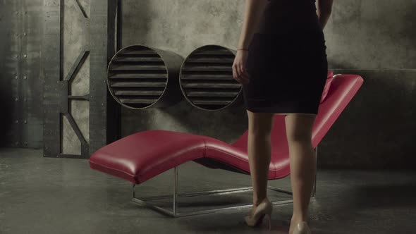 Seductive Vamp Woman Relaxing in Lounge Chair alt