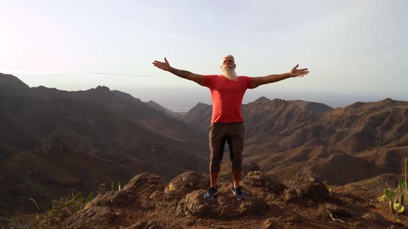 Senior Man Greeting Sunset alt